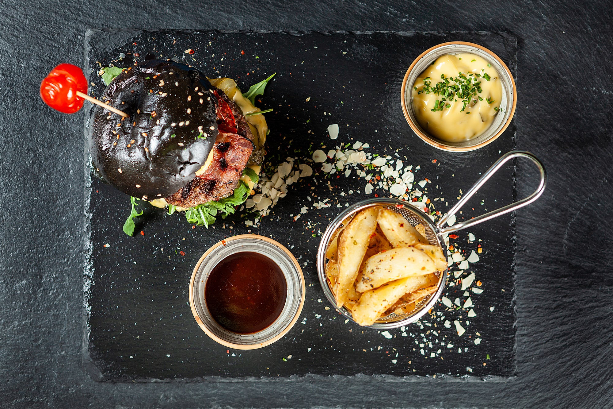 burger-and-friench-fries-on-black-stone-table-chee-E7PRL84-min